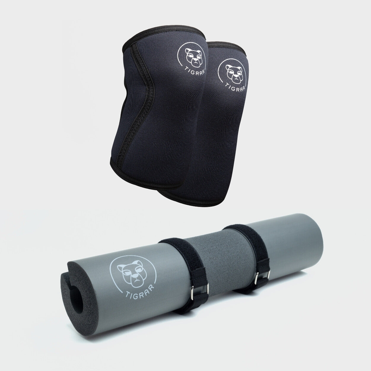 Tigrar fitness bundel met slijtvaste zwarte knee sleeves en een schokabsorberende grijze barbell pad. Perfect voor intensieve krachttrainingssessies.