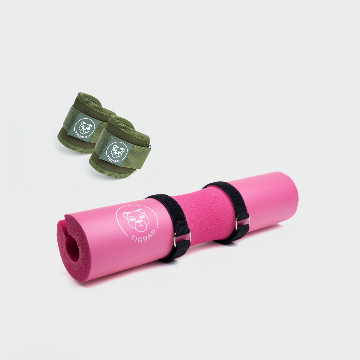Roze hip thrust pad en groene enkel straps, ideaal voor squats en beenoefeningen.