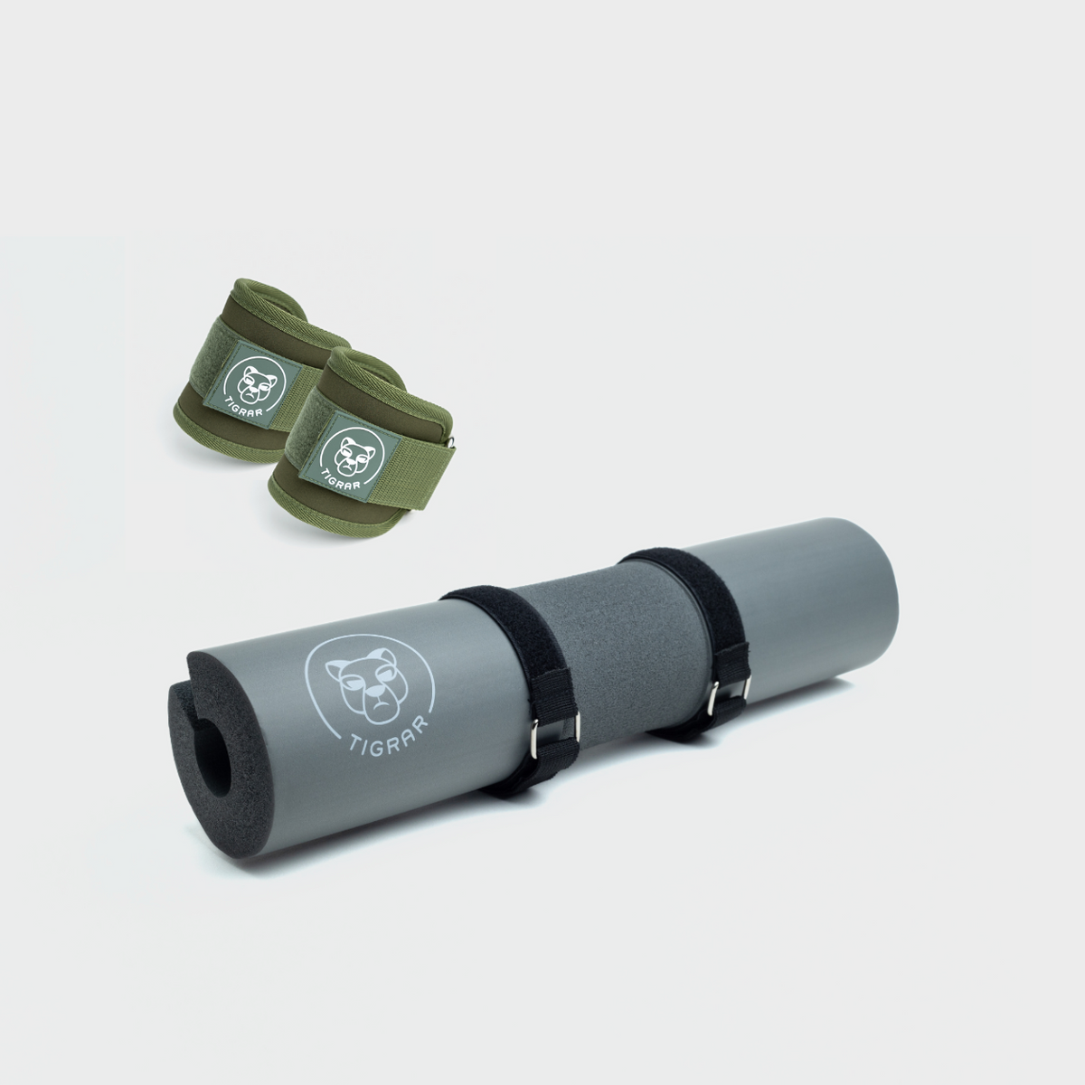 Grijze hip thrust pad en groene enkel straps van Tigrar voor krachttraining.