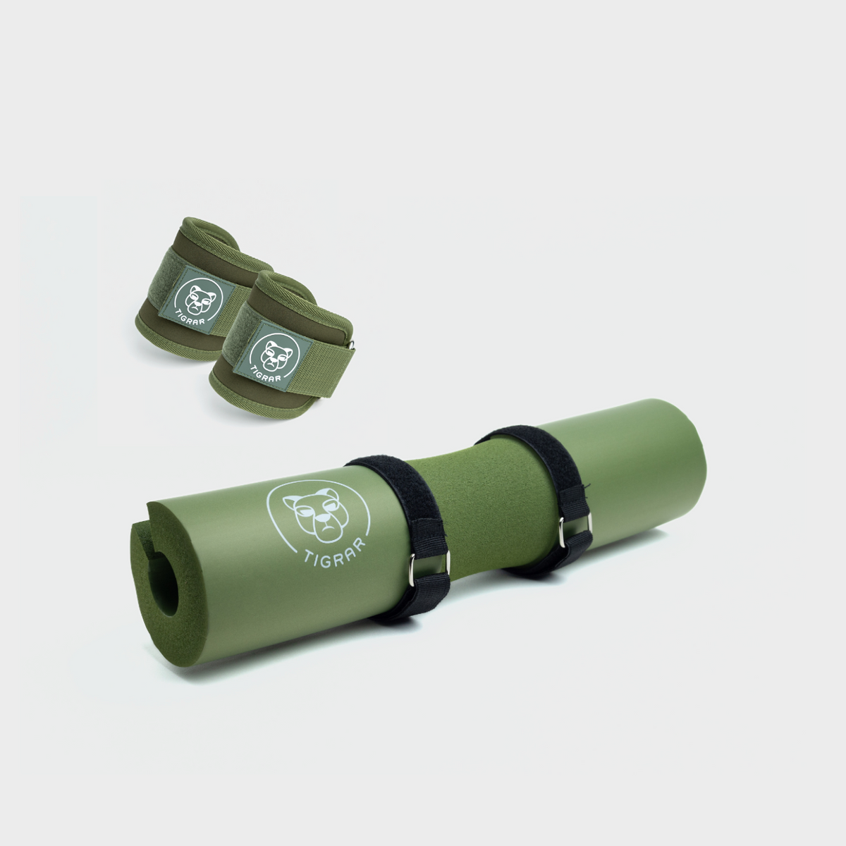 Groene Tigrar hip thrust pad en groene gym enkel straps voor squats en beenoefeningen.