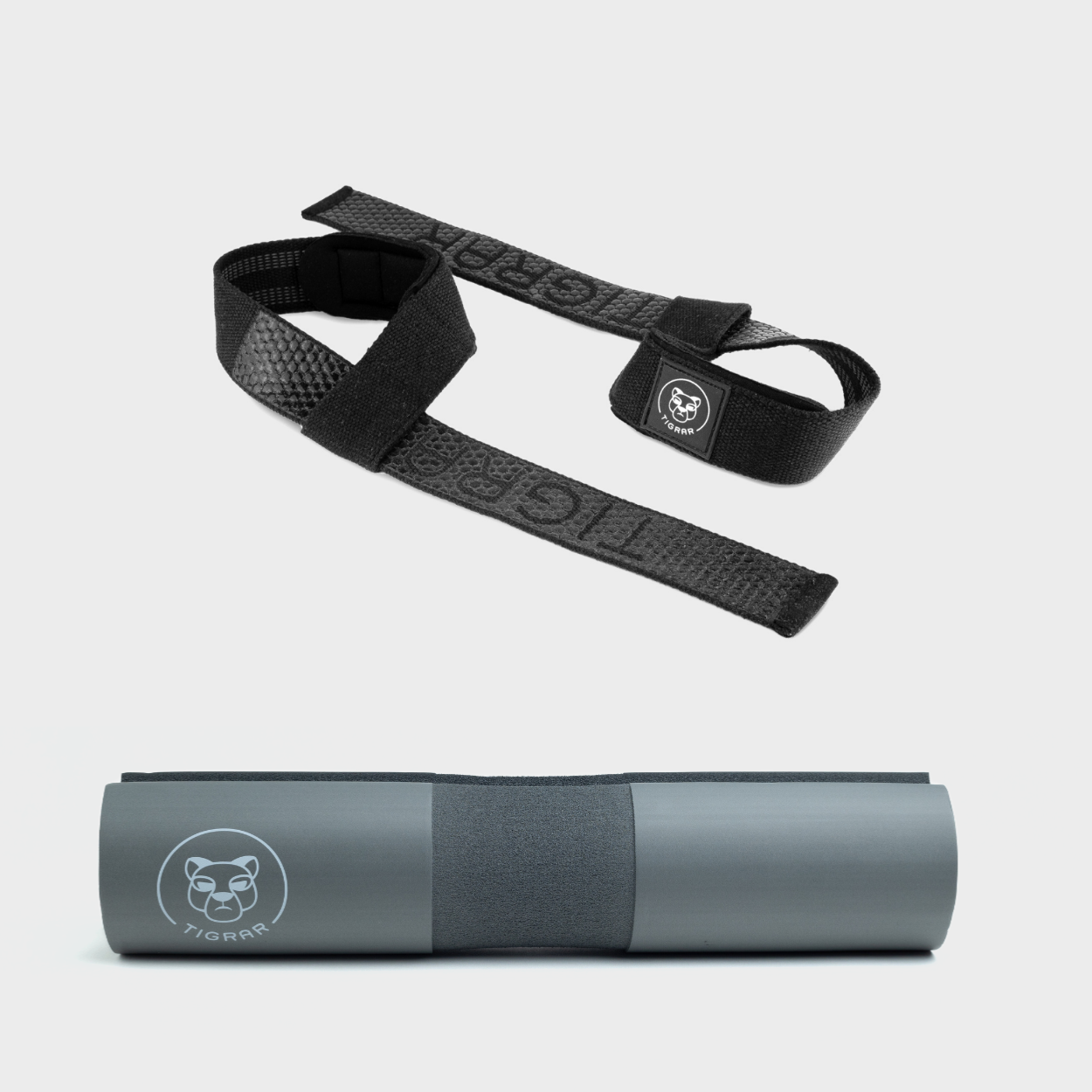 Zwarte Tigrar lifting straps en grijze barbell pad, beiden anti-slip en slijtvast voor de meest uitdagende lifts.