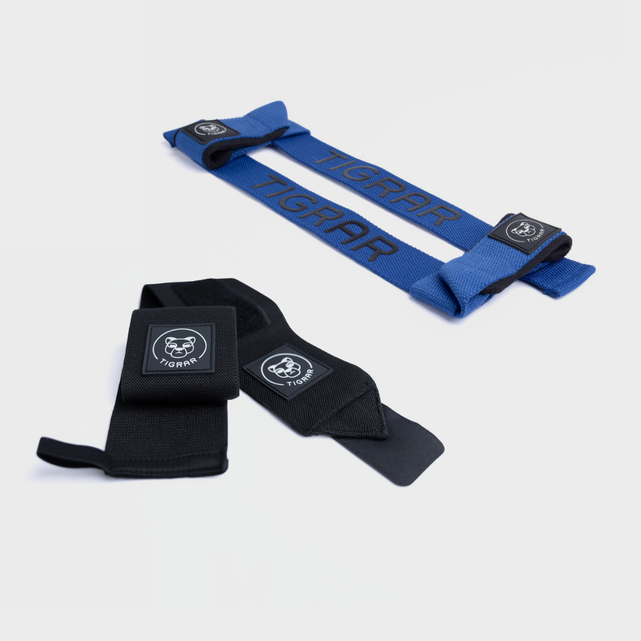 "Zwarte Tigrar wrist straps en blauwe weight lifting straps, ideaal voor gewichtheffen en powerlifting.