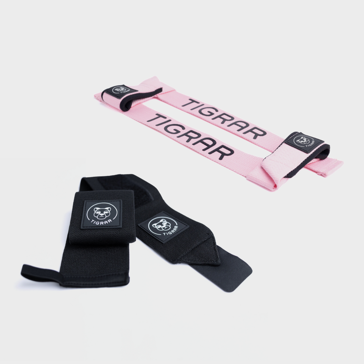 Roze weightlifting straps en zwarte wrist straps van Tigrar voor verbeterde grip en polsondersteuning bij zware gewichthefoefeningen
