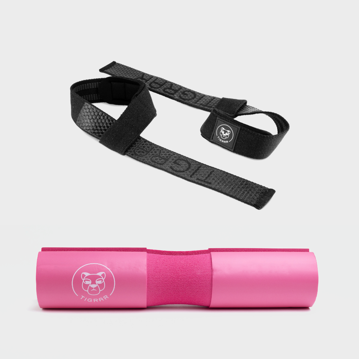 Contrasterende zwarte lifting straps met roze Tigrar barbell pad, combineert slijtvastheid met beschermend comfort.