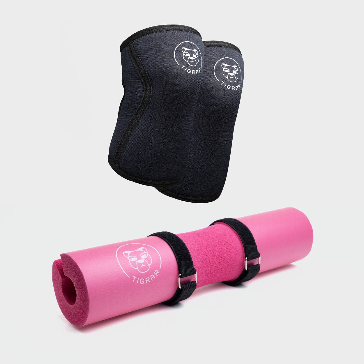 Tigrar's zwarte neopreen knee sleeves naast een schokabsorberende roze barbell pad, ontworpen voor duurzaamheid en comfort tijdens elke workout.
