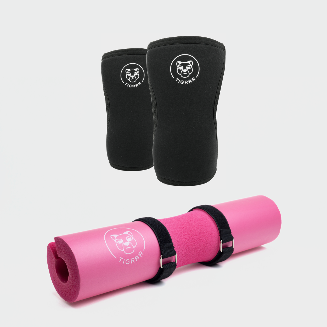 Tigrar fitness set met zwarte knee sleeves en een opvallende roze barbell pad, ideaal voor zowel stijl als bescherming tijdens trainingen.