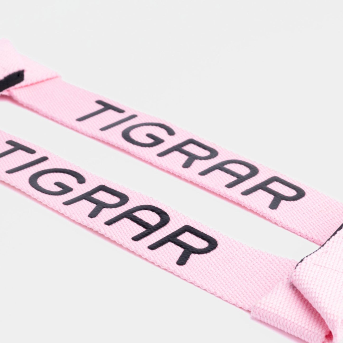 Close-up van roze Tigrar lifting straps, ontworpen voor een stevige grip en comfort tijdens trainingssessies.