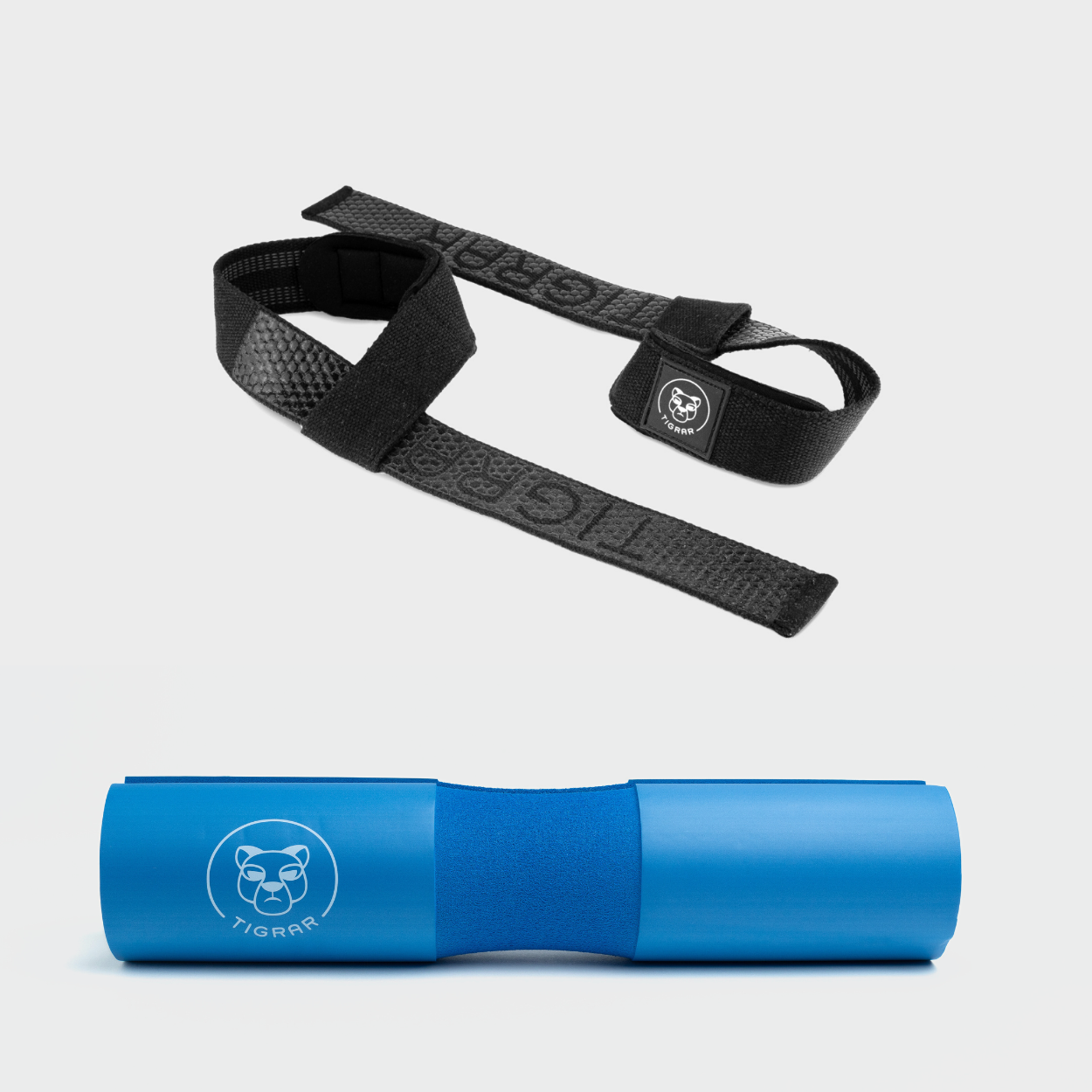 Krachtige combinatie van zwarte Tigrar straps en blauwe barbell pad, ideaal voor veiligheid en ondersteuning bij elke lift.