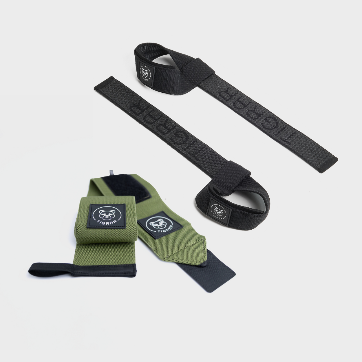 Tigrar set van groene wrist straps en zwarte weight lifting straps, perfect voor krachttraining en polsondersteuning.