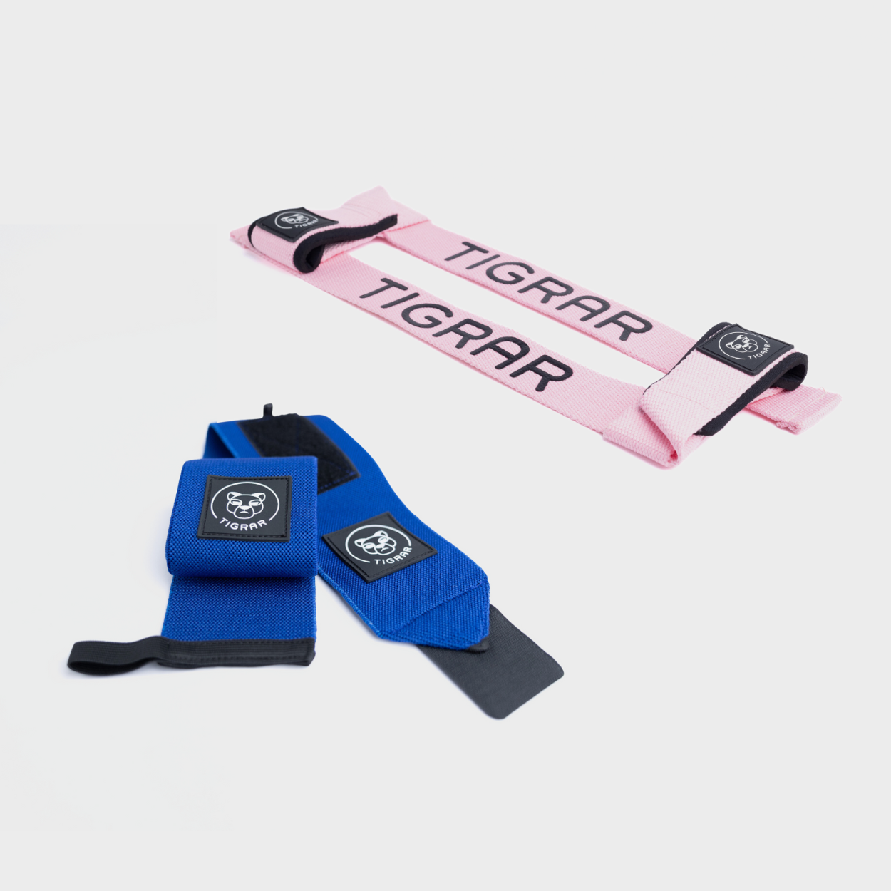 Blauwe wrist straps en roze weight lifting straps van Tigrar voor extra polssteun en grip tijdens crossfit en powerlifting