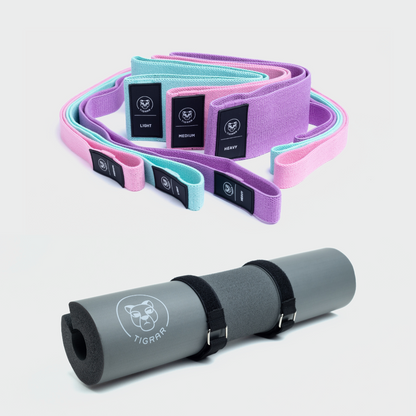 Grijze Tigrar barbell pad met bevestigingsbandjes, samen met drie korte en drie lange fitness elastieken in mint, roze en paars.