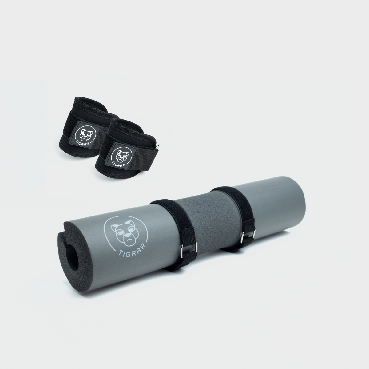 Grijze hip thrust foam pad en zwarte enkel straps, essentiële uitrusting voor hip thrusts.