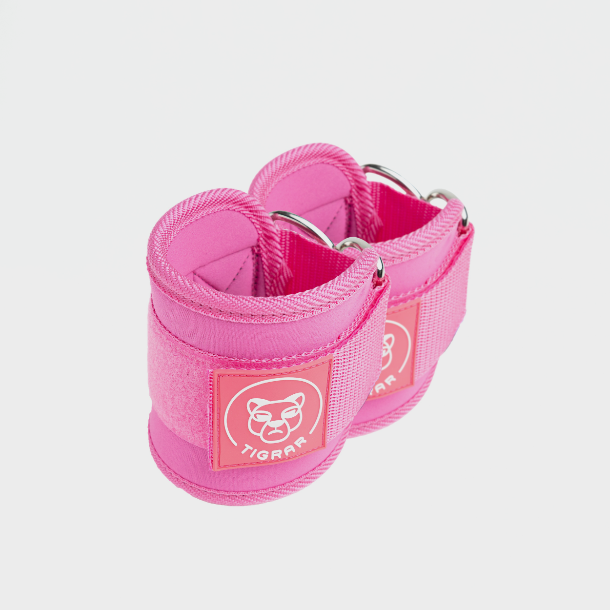 Roze Tigrar enkel straps met klittenbandsluiting. Lichtgewicht ontwerp, geschikt voor dagelijkse trainingsroutines. Gebruikt voor stabiliteitsoefeningen.