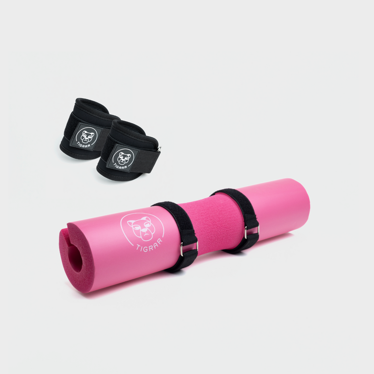 Roze hip thrust foam pad en zwarte enkel straps, stevige bescherming voor zware lifts.
