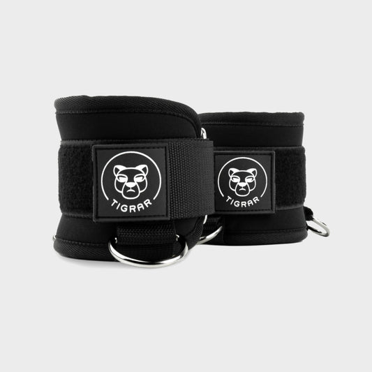 Zwarte Tigrar kickback ankle straps met neopreen padding, perfect voor cable machine oefeningen in de gym.
