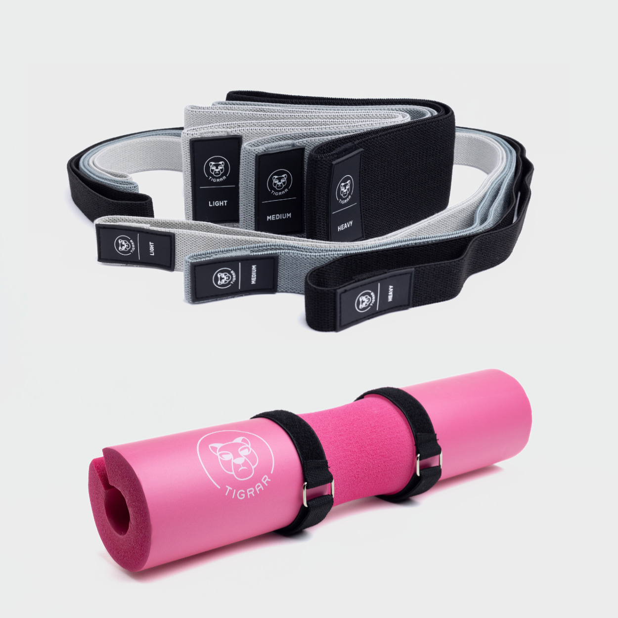 Roze Tigrar barbell pad met drie korte en drie lange weerstandsbanden. Weerstand variërend van light tot heavy, in zwart, grijs en lichtgrijs.